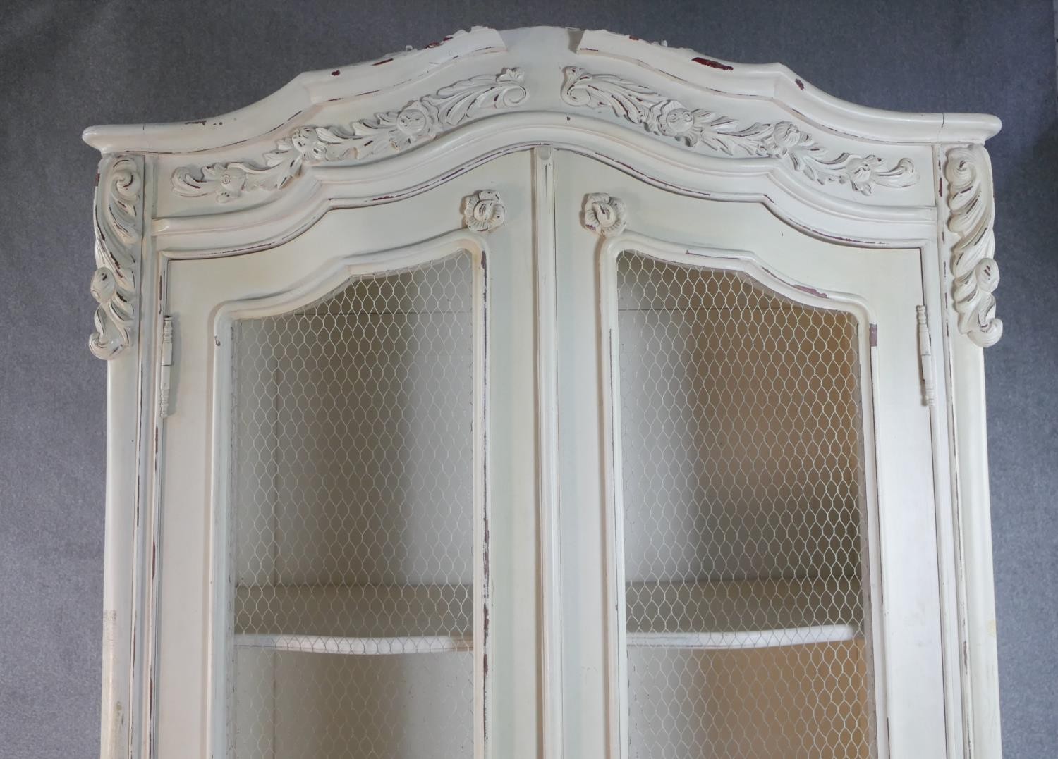 A French white painted and distressed bibliotheque, the carved cornice over two doors with mesh - Image 3 of 7