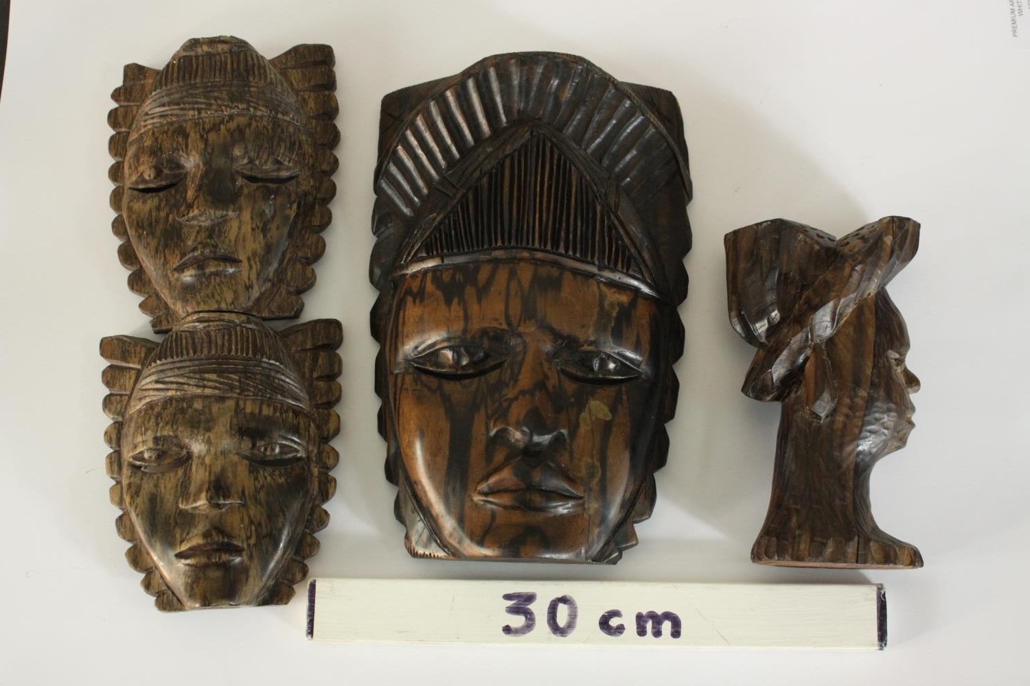A carved African tribal mask along with a carved male bust in a hat and a double headed mask. H.27 - Image 2 of 8