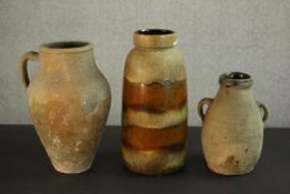 Two Mediterranean terracotta oil jars and a West German brown glaze vase. H.40 Dia.16cm. (largest)