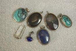 A collection seven silver and gemstone set pendants. Gemstones include: turquoise, lapis lazuli,