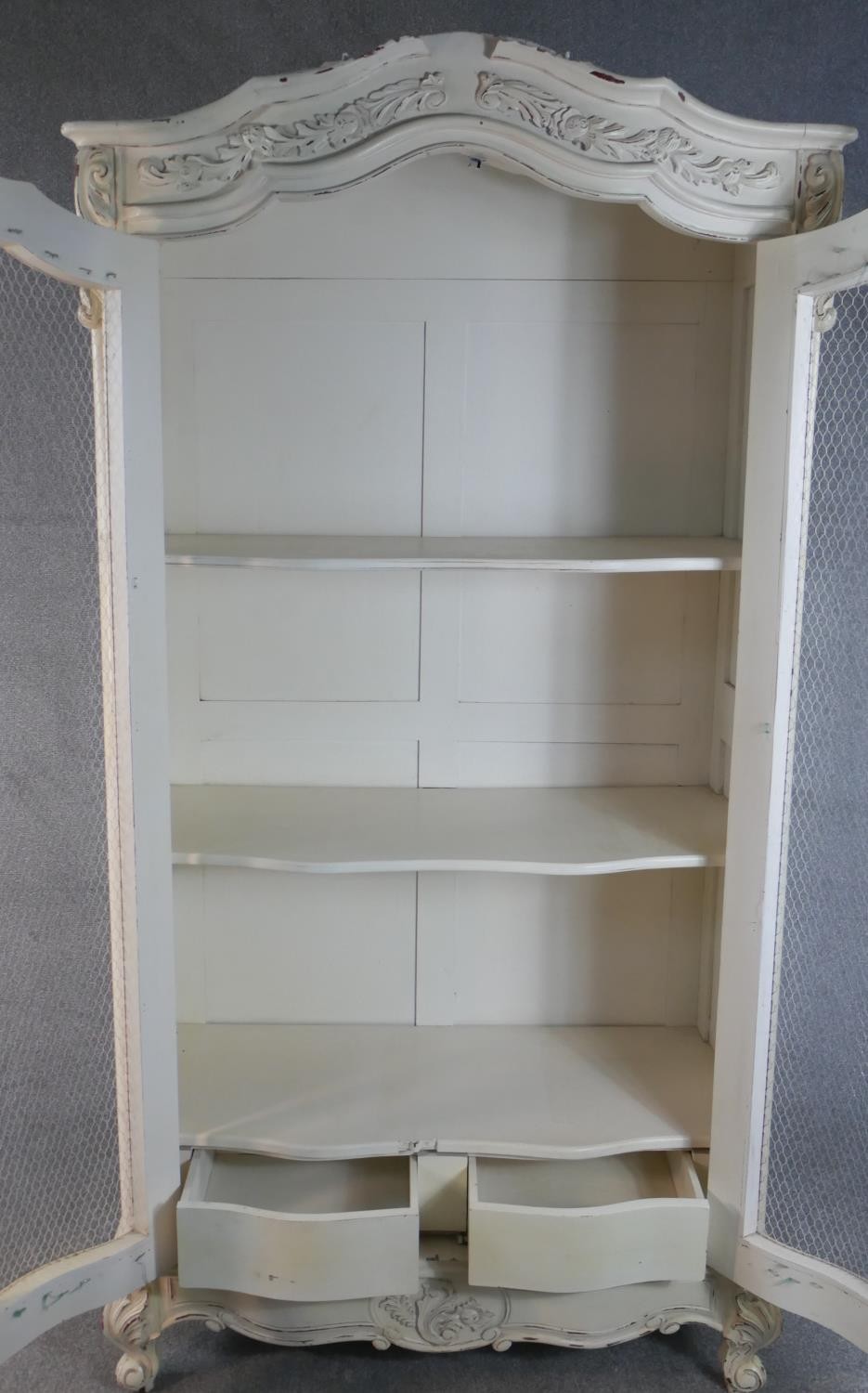 A French white painted and distressed bibliotheque, the carved cornice over two doors with mesh - Image 6 of 7