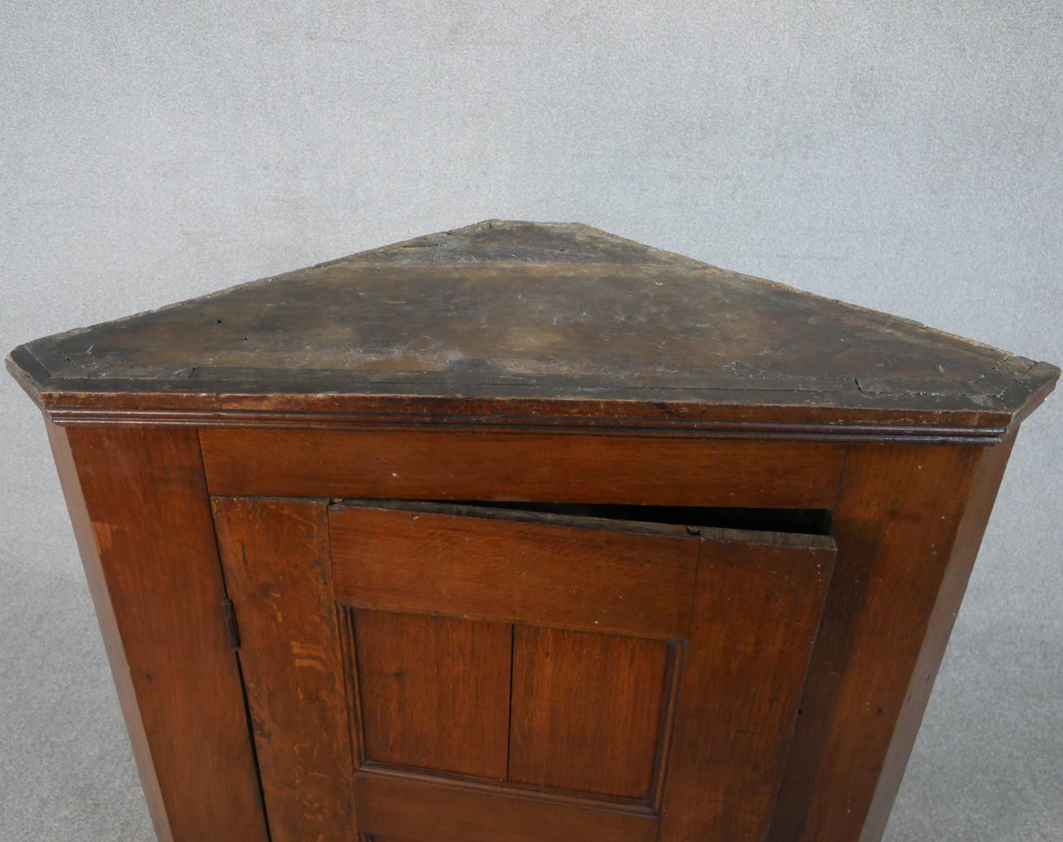 A 19th century oak hanging corner cabinet with panel door enclosing two shelves. H.106 W.94.5 W.46cm - Image 2 of 5