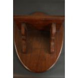 A Victorian walnut wall shelf on a shield shaped back. H.45 W.37 D.23cm.