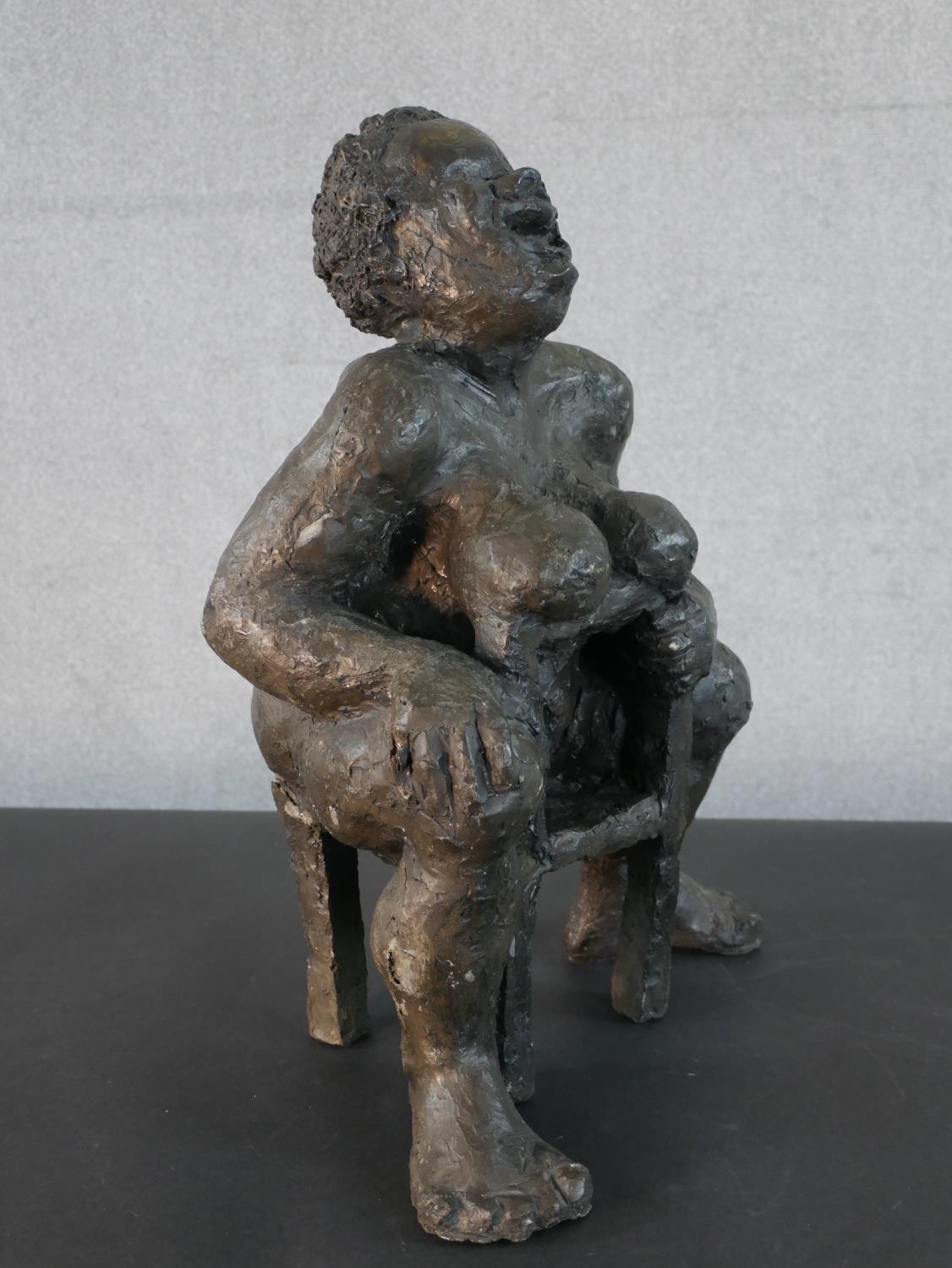 A bronzed moulded figure of a nude woman on a seat laughing, indistinctly signed. H.49 W.36 D.20cm - Image 2 of 6