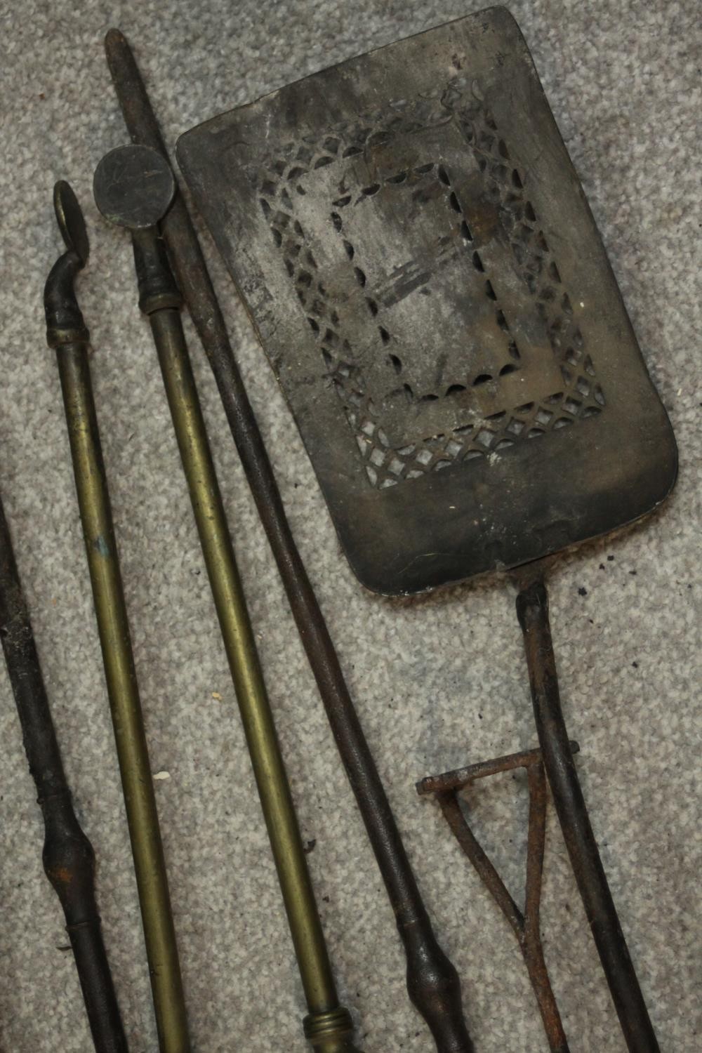 A collection of early 20th century cast iron and brass fire irons, other tools and a cast iron three - Image 4 of 7