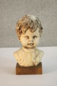 A ceramic bust of a young boy, indistinctly signed. H.28 W.14 D.14cm.