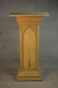 A Gothic Revival oak and pine sculpture stand, with a rectangular top, the sides with arched design,