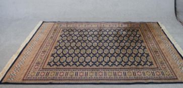 A blue ground Bukhara motif carpet. L.224 W.162cm