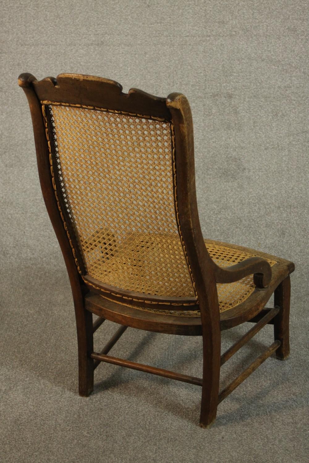 A circa 1900 hardwood nursing chair, with a caned seat and back, the legs joined by stretchers. - Image 5 of 7