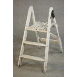 A vintage white painted wooden step ladder, folding and with three steps. H.88 W.35 D.70cm.