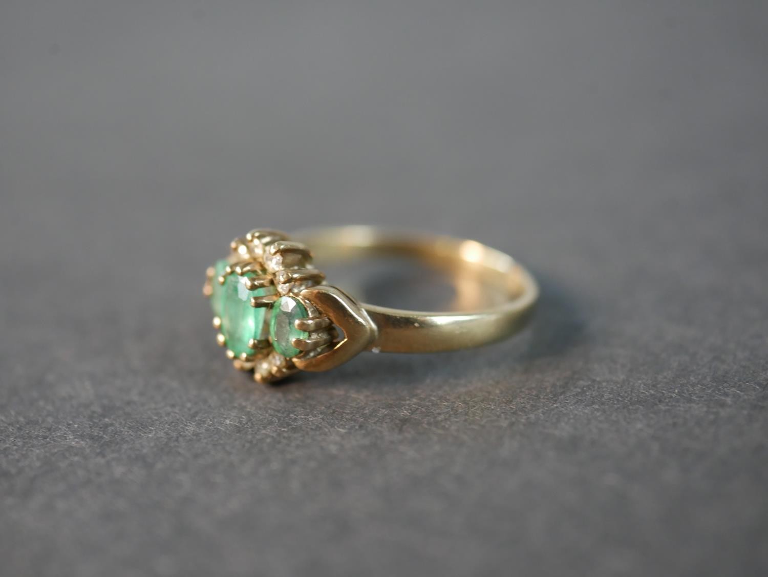 A 9 carat yellow gold emerald and diamond three stone ring, set with three oval mixed cut emeralds - Image 2 of 5