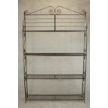 A wrought iron baker's rack, with four shelves, the sides with S shaped scrolling designs. H.200 W.