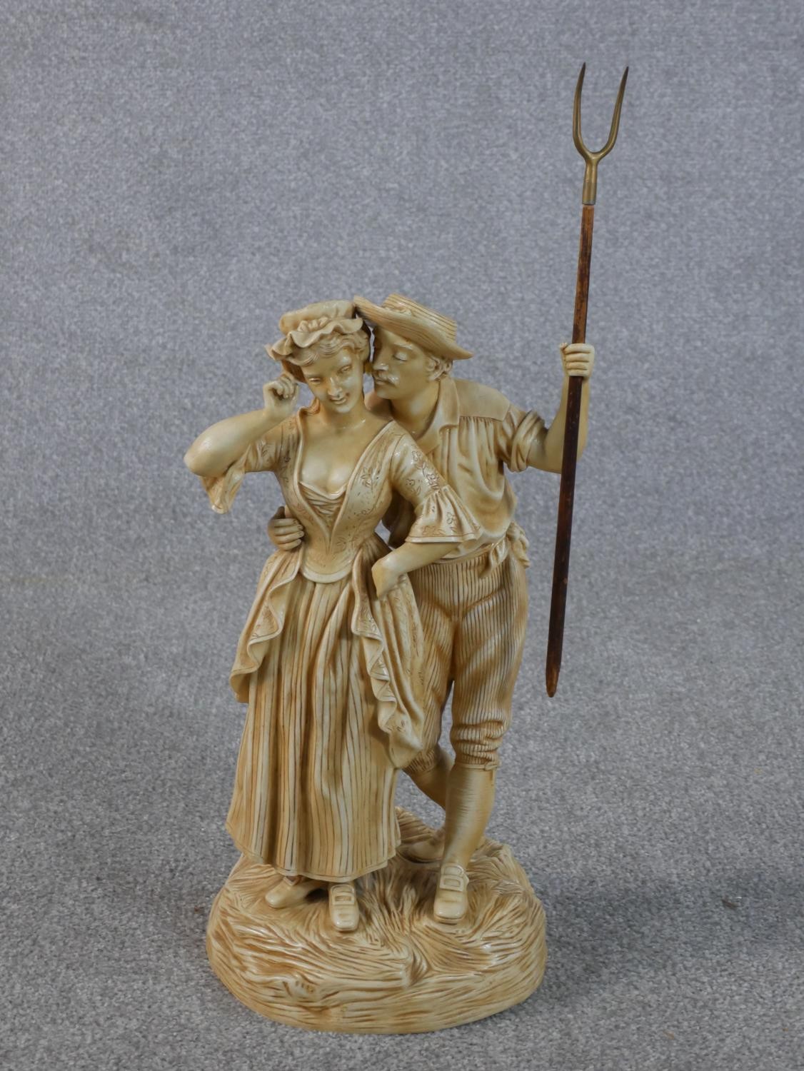 A large Victorian cream glazed ceramic figure group of the haymaker and the milk maid embracing. The