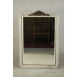 A rectangular wall mirror, in a grey painted and distressed frame with a white painted slip, with