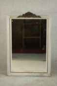 A rectangular wall mirror, in a grey painted and distressed frame with a white painted slip, with