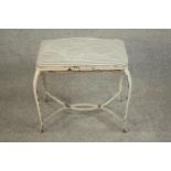 A white painted wrought iron stool, probably French, the seat upholstered in striped black and white