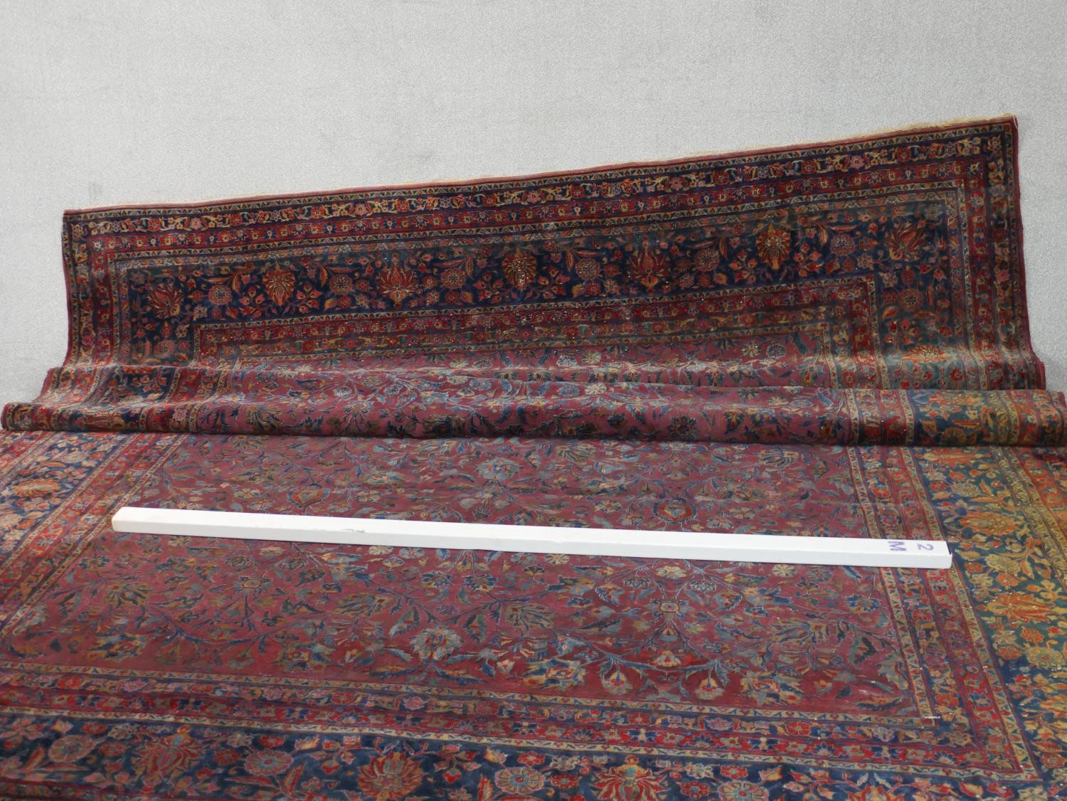 A fine hand woven Persian Sarouk carpet with scrolling foliate decoration across the burgundy - Image 2 of 7