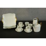 A Wedgwood five person white and gold part tea set. (damage to two cups and coffee pot.) H.14 Dia.