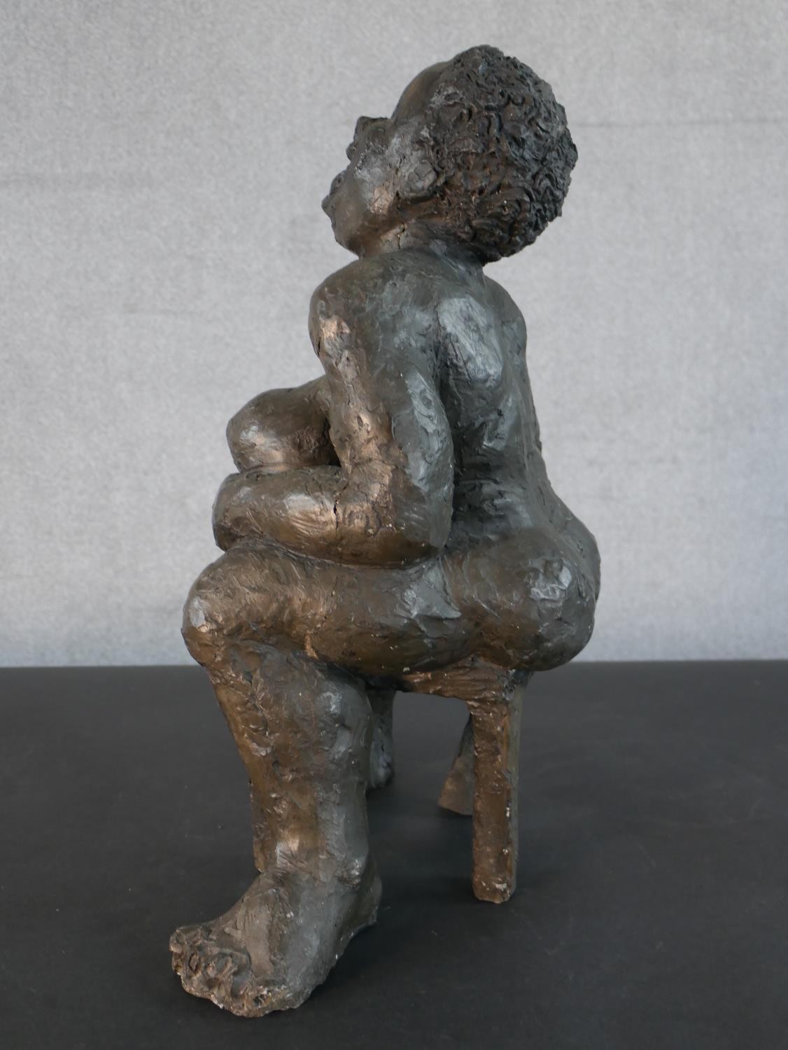 A bronzed moulded figure of a nude woman on a seat laughing, indistinctly signed. H.49 W.36 D.20cm - Image 5 of 6