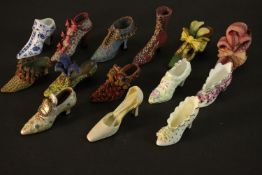 A collection of fourteen miniature shoes and boots, four hand painted and transfer printed porcelain