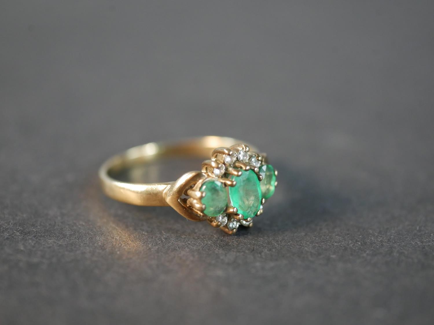 A 9 carat yellow gold emerald and diamond three stone ring, set with three oval mixed cut emeralds - Image 5 of 5