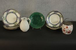 A collection of Royal Doulton Merryweather plates and bowls, along with a 19th century green glaze