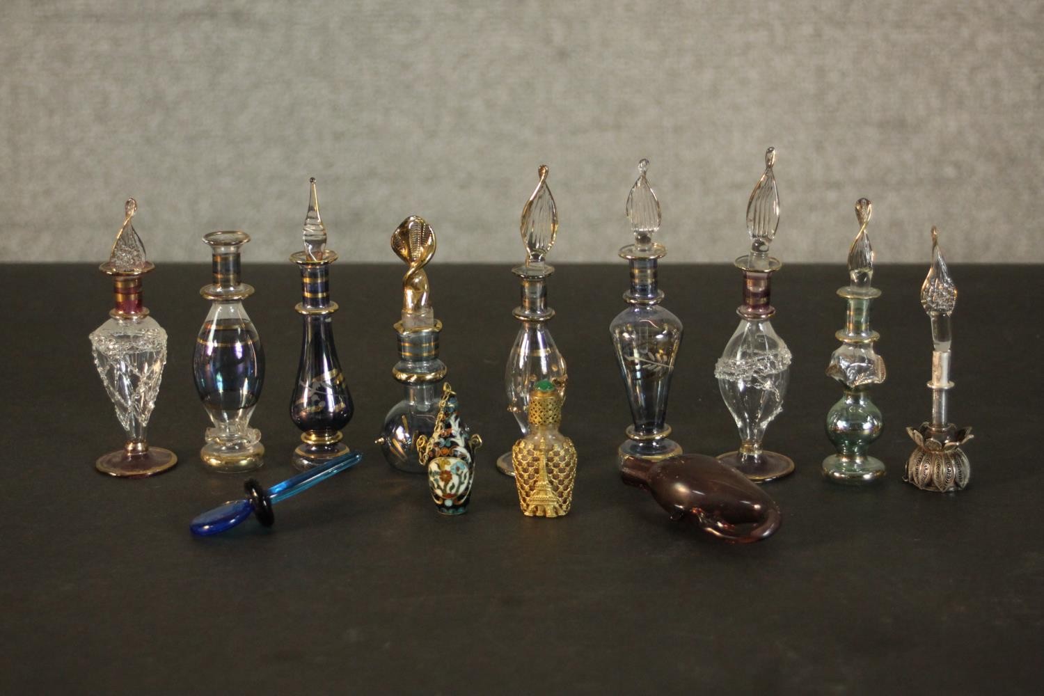 A collection of perfume and snuff bottles, including nine hand blown glass Egyptian bottles with