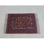 An Afghan rug with all over geometric design. L.69 W.53cm