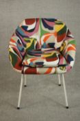 Attributed to Robin Day, a tub chair upholstered in polychrome abstract fabric, on white powder