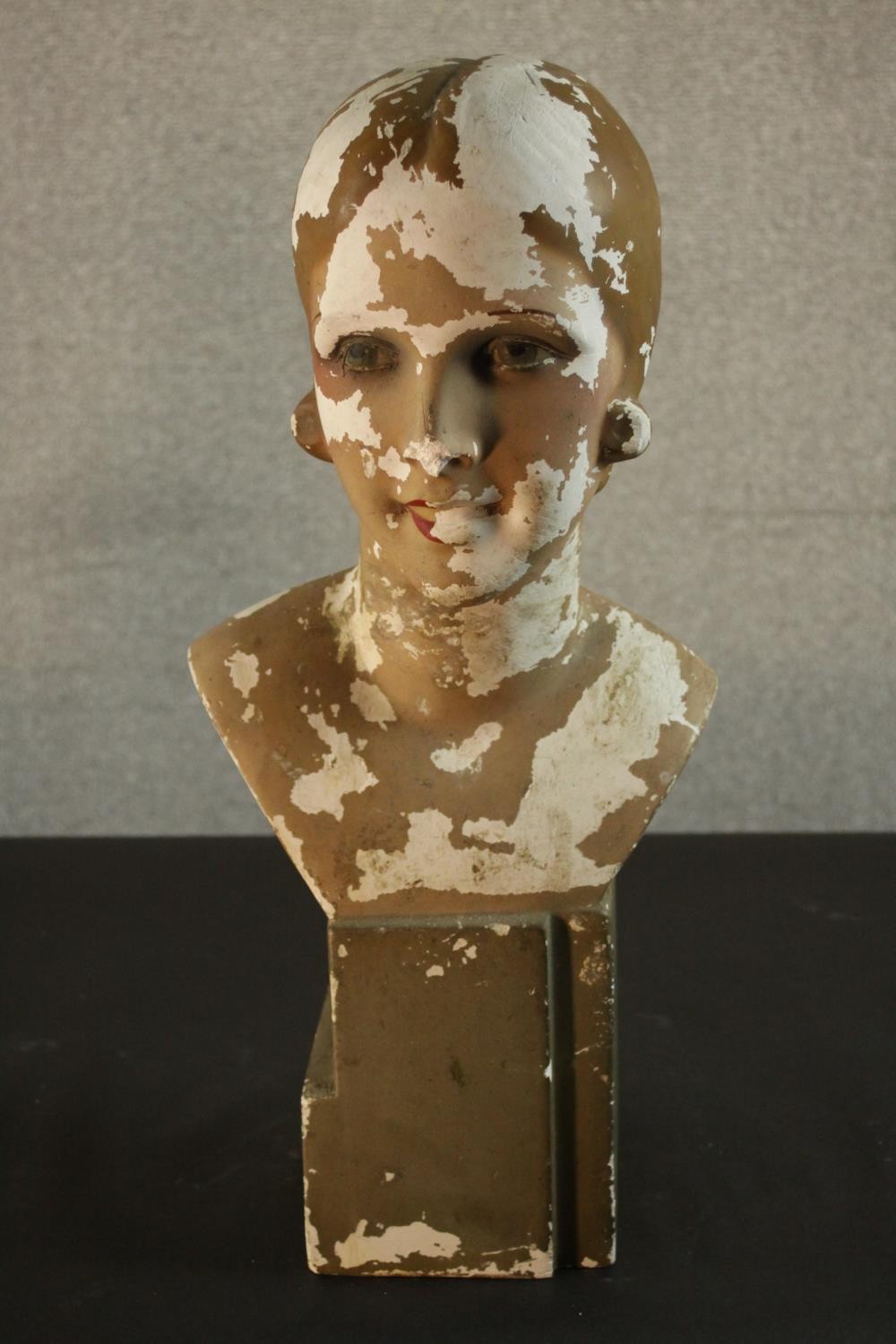 A circa 1930's painted plaster female mannequin bust. Damaged. H.57 W.27 D.25cm.