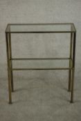 A 1970's brass console table, of rectangular form with two plate glass tiers. H.72 W.61 D.25cm.