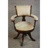 A Victorian simulated rosewood desk chair, upholstered in cream velour to the back, arms and seat,