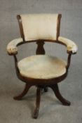 A Victorian simulated rosewood desk chair, upholstered in cream velour to the back, arms and seat,