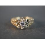 A 9 carat yellow gold and white metal diamond ring, set to centre with a round brilliant cut diamond