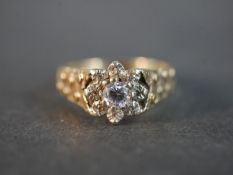 A 9 carat yellow gold and white metal diamond ring, set to centre with a round brilliant cut diamond