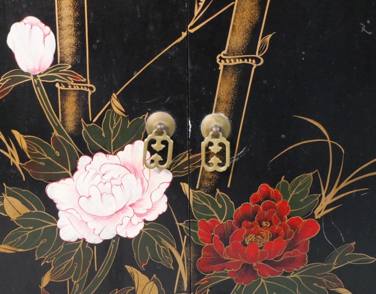 A Chinese peony and bamboo design black lacquered and gilt cabinet with two doors and three - Image 5 of 5