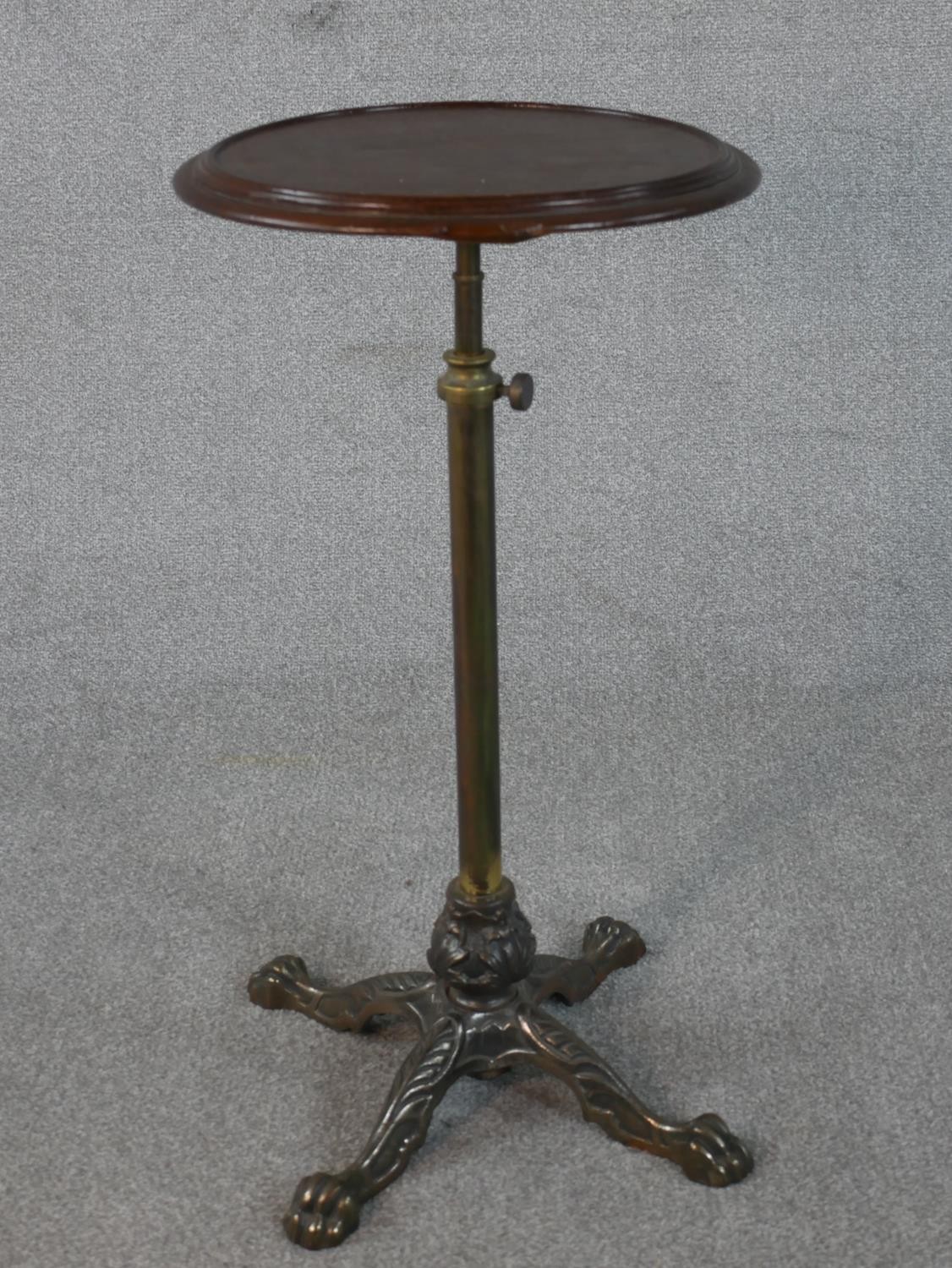 A late Victorian adjustable occasional or lamp table, the circular dished top on a telescopic