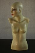 An early 20th century cast wax female mannequin with glass eyes and painted facial features. H.72