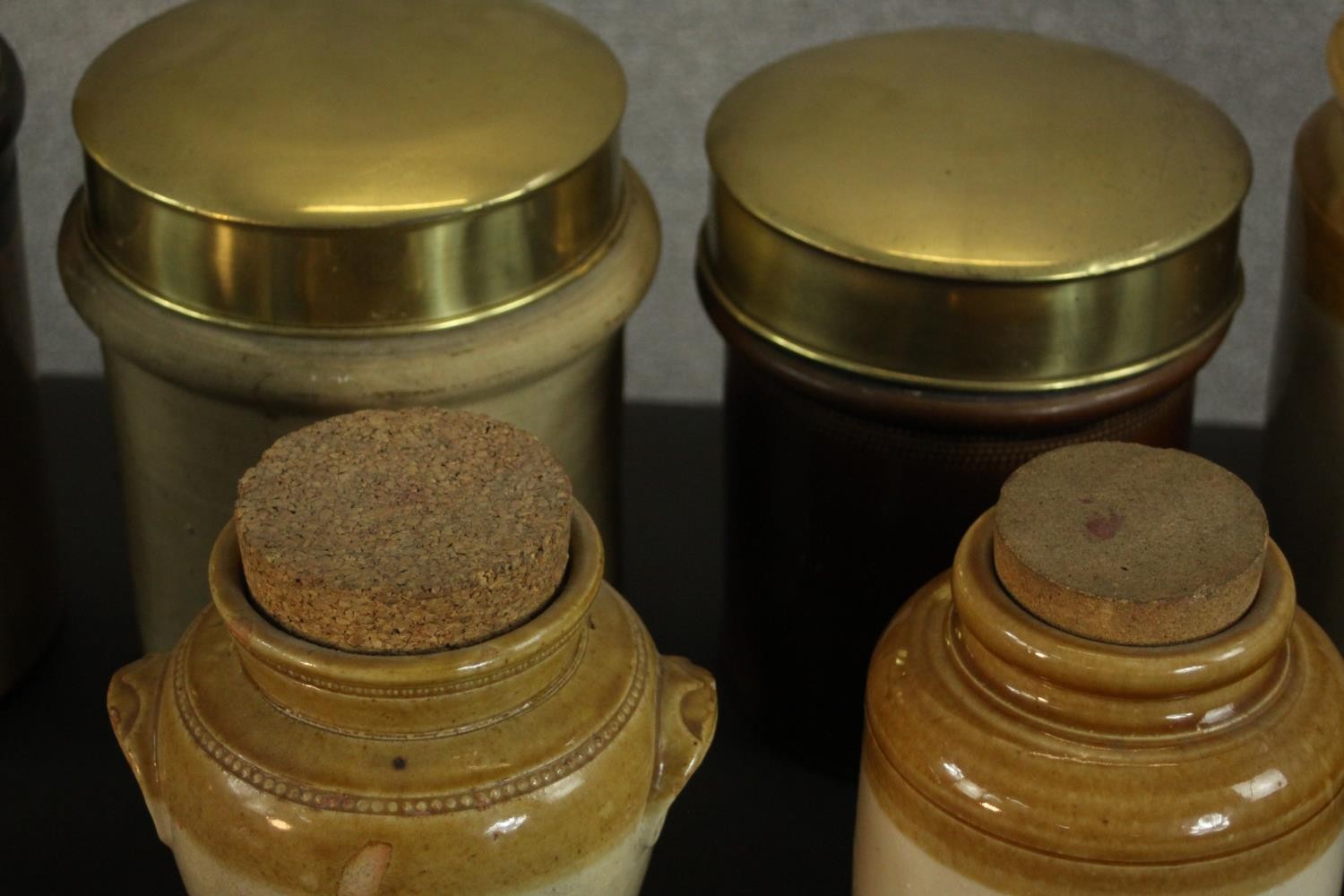 A collection of early 20th century honey glaze earthenware food storage jars, three with brass lids. - Image 4 of 8