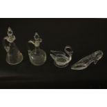 A collection of glass and crystal, including two oil bottles one with an engraved design, a
