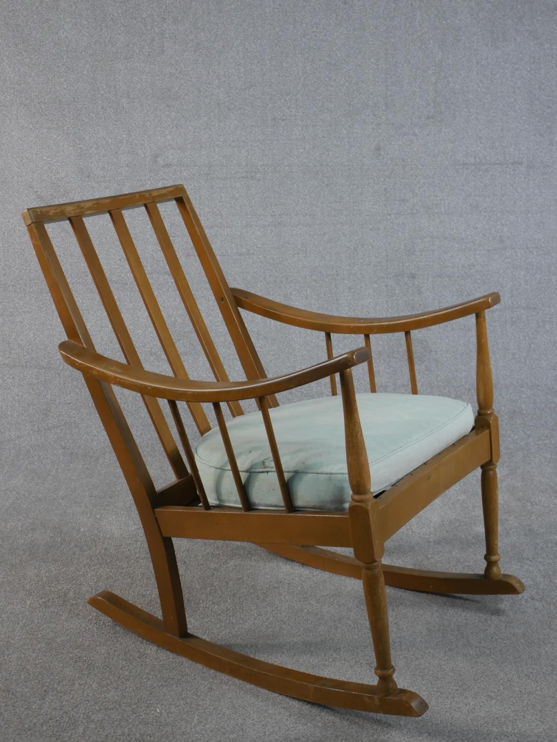 A mid 20th century beech rocking chair, with a spindle back and a blue upholstered loose cushion, on - Image 5 of 5