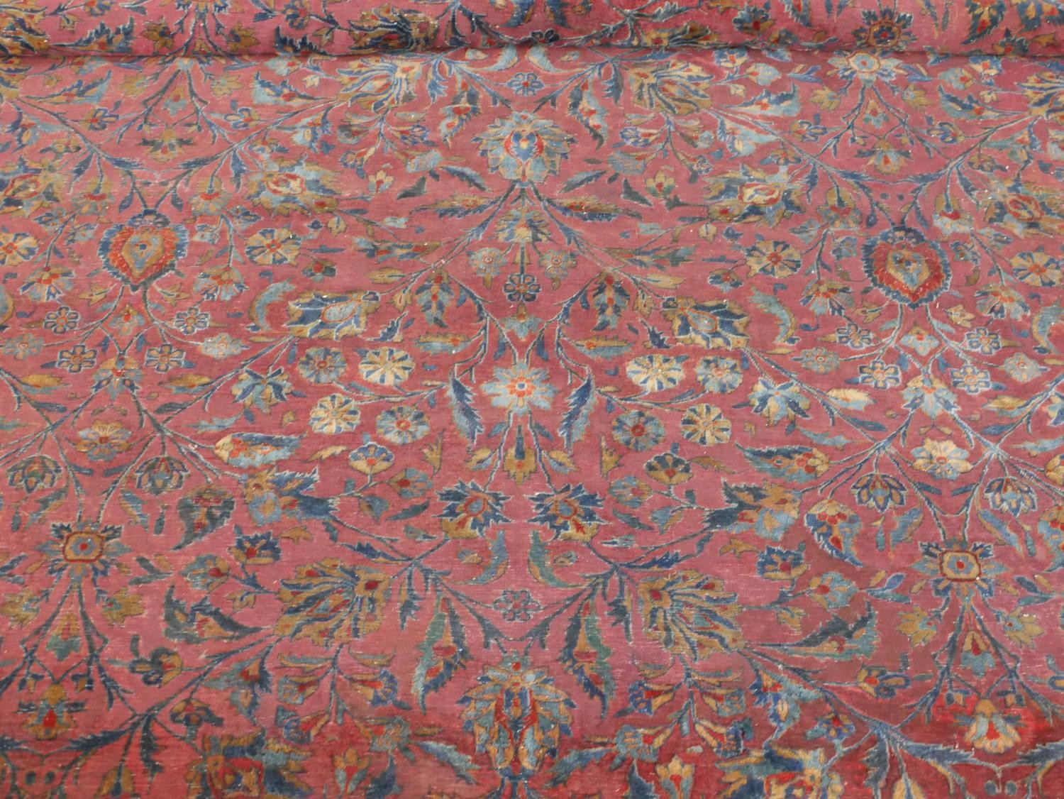 A fine hand woven Persian Sarouk carpet with scrolling foliate decoration across the burgundy - Image 4 of 7