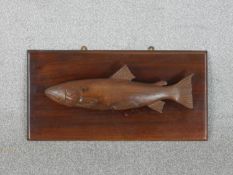 A wall mounted carving of a salmon. H.27.5 W.54.5cm