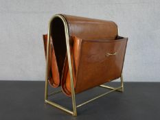 A brass and tan leather vintage style magazine rack with brass stirrup detailing. H.38 W.38 D.20cm