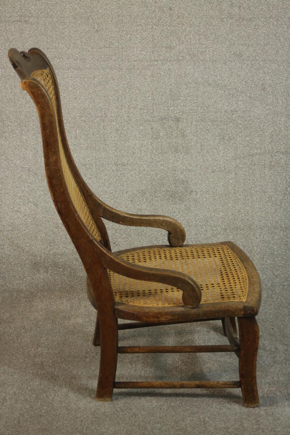 A circa 1900 hardwood nursing chair, with a caned seat and back, the legs joined by stretchers. - Image 4 of 7