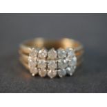 A 9 carat yellow gold and diamond dress ring set with fifteen round brilliant cut diamonds with a