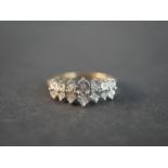 A 9ct yellow and white gold diamond dress ring set with fourteen round eight cut diamonds in