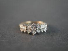 A 9ct yellow and white gold diamond dress ring set with fourteen round eight cut diamonds in