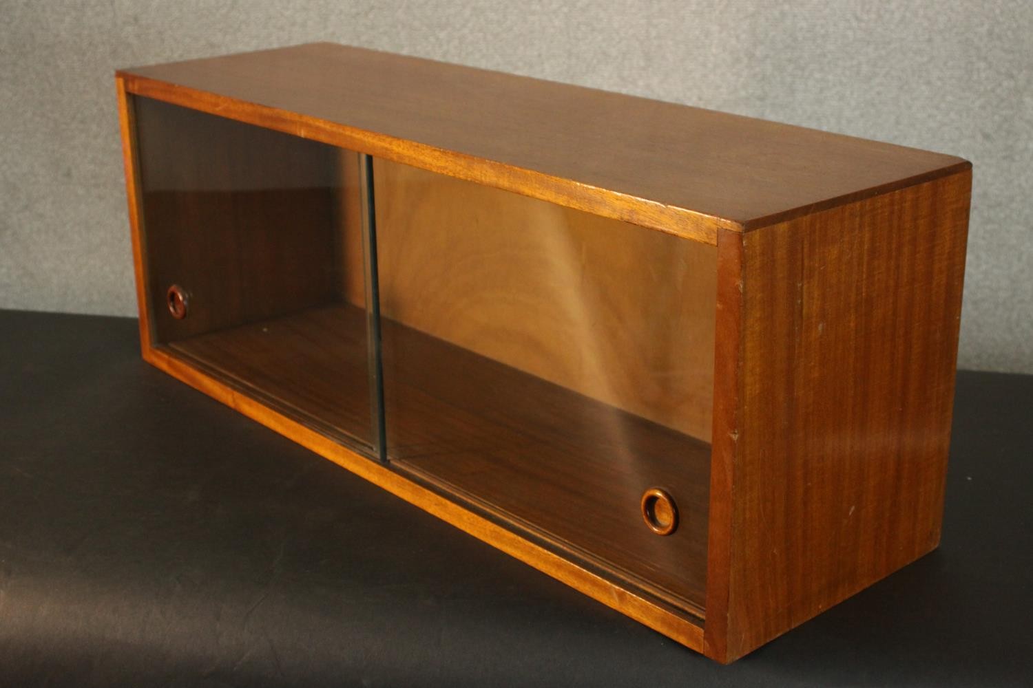 A circa 1950s teak cabinet, of rectangular form with two sliding glass doors. H.31 W.84 D.26cm. - Image 5 of 6