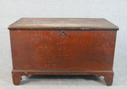 An early 19th century oak blanket box, the rectangular top opening to reveal a blue painted interior